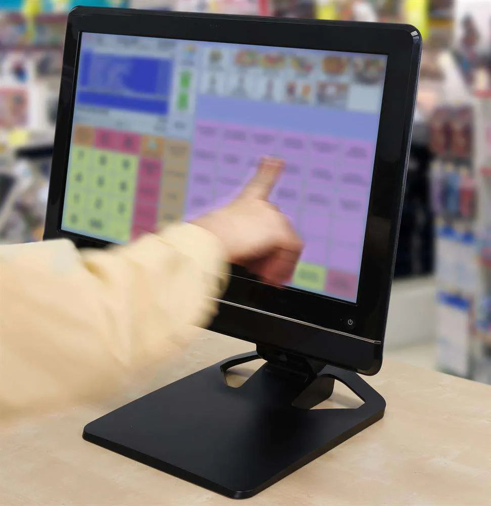Hand interacting with a black touchscreen monitor, demonstrating an anti-glare screen in a bright retail setting.