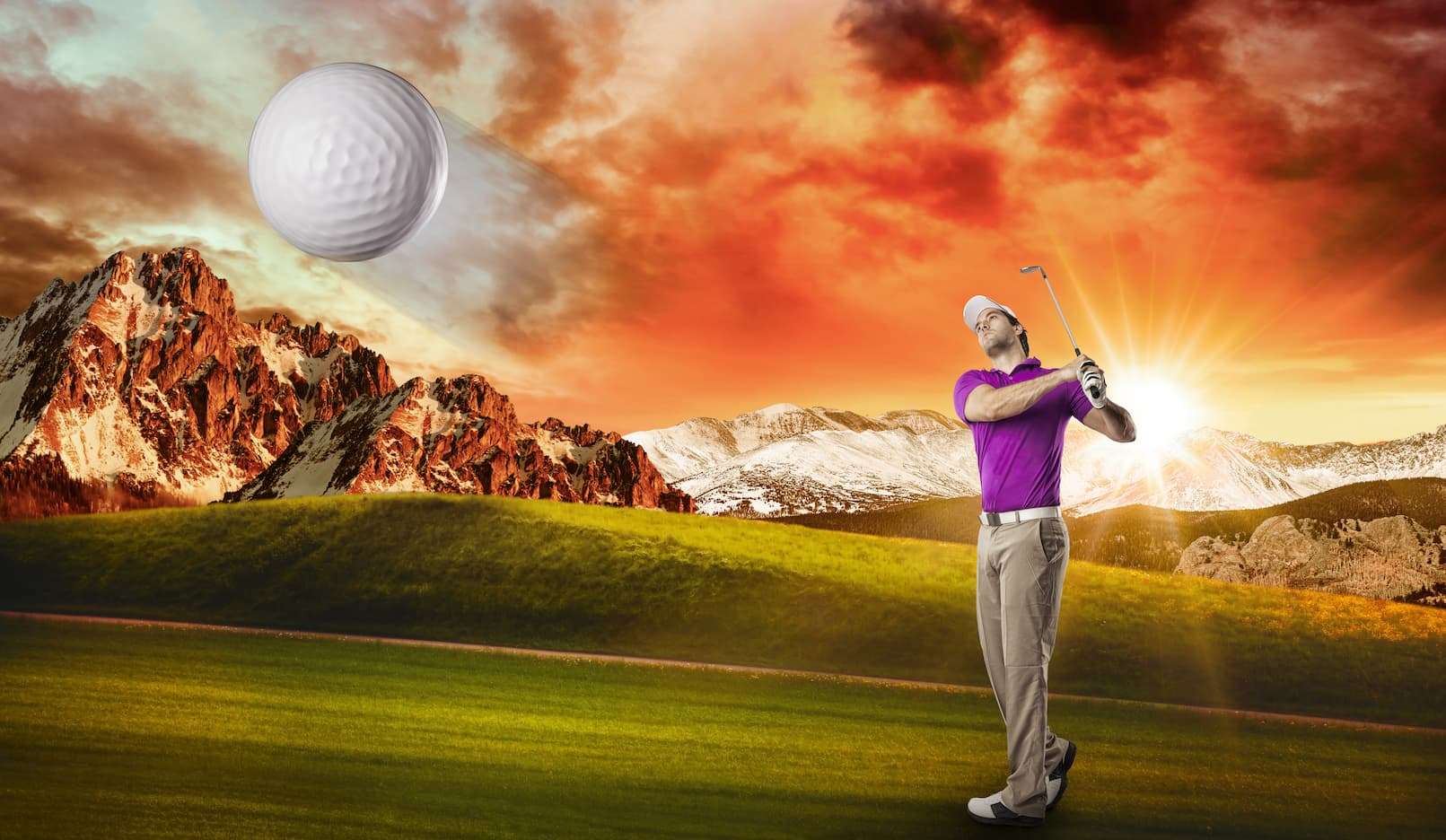 Golfer hitting a shot in virtual golf simulator with mountain backdrop