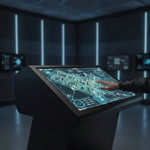 Touch Screen Guru Ultra-Series 32-inch 4K touch monitor displaying a blueprint with a hand interacting. Features zero bezel, 10-point multi-touch, and 500+ nits brightness.